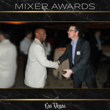 Mixer Awards Las Vegas | Business Recognition for Creative Leadership Charles Starr receiving a Mixer Awards recognition in Las Vegas, shaking hands with the event host for creative and impactful business contributions.